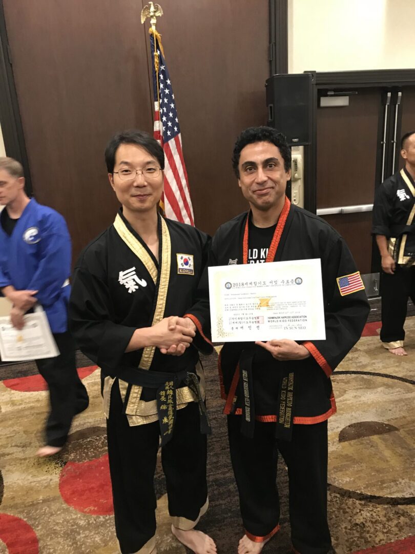 A martial arts athlete being awarded a certificate